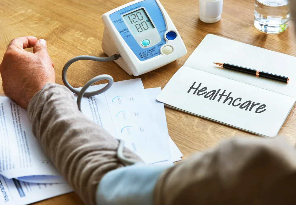 Digital blood pressure monitor reading 120/80 mmHg during a clinical hypertension diet chart evaluation.