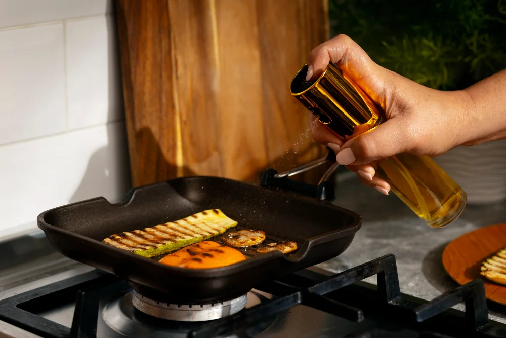 Using an oil spray bottle with the best cooking oil for heart patients to strictly manage dietary fat portions while cooking.