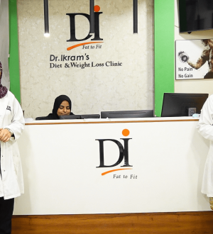Clinical team at Dr. Ikram's Diet and Weight Loss Clinic reception desk providing medical guidance to overcome a weight loss plateau in Karachi