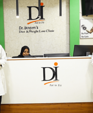 Clinical team at Dr. Ikram's Diet and Weight Loss Clinic reception desk providing medical guidance to overcome a weight loss plateau in Karachi