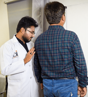 Doctor at Dr. Ikram Diet and Weight Loss Clinic performing a physical assessment to treat obesity as a medical condition.
