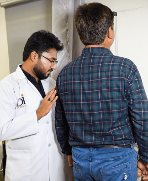 Doctor at Dr. Ikram Diet and Weight Loss Clinic performing a physical assessment to treat obesity as a medical condition.