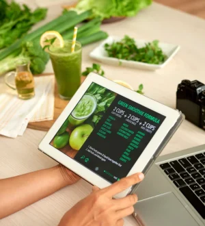 Person holding a tablet displaying a digital meal formula while researching AI chatbots for health and diet plans alongside fresh ingredients.