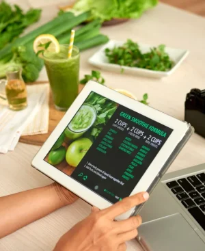 Person holding a tablet displaying a digital meal formula while researching AI chatbots for health and diet plans alongside fresh ingredients.