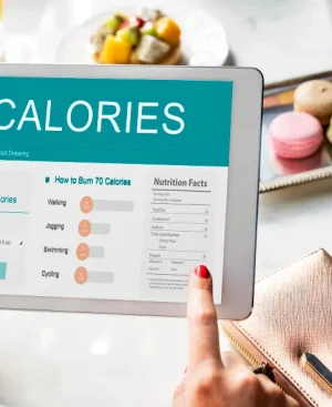 A person using a digital tablet to track metabolic eating vs calorie counting Karachi for fat loss.