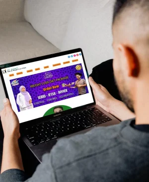 A patient viewing Dr. Ikram's diet and weight loss website on a laptop, consulting an online doctor in Pakistan from the comfort of their home.